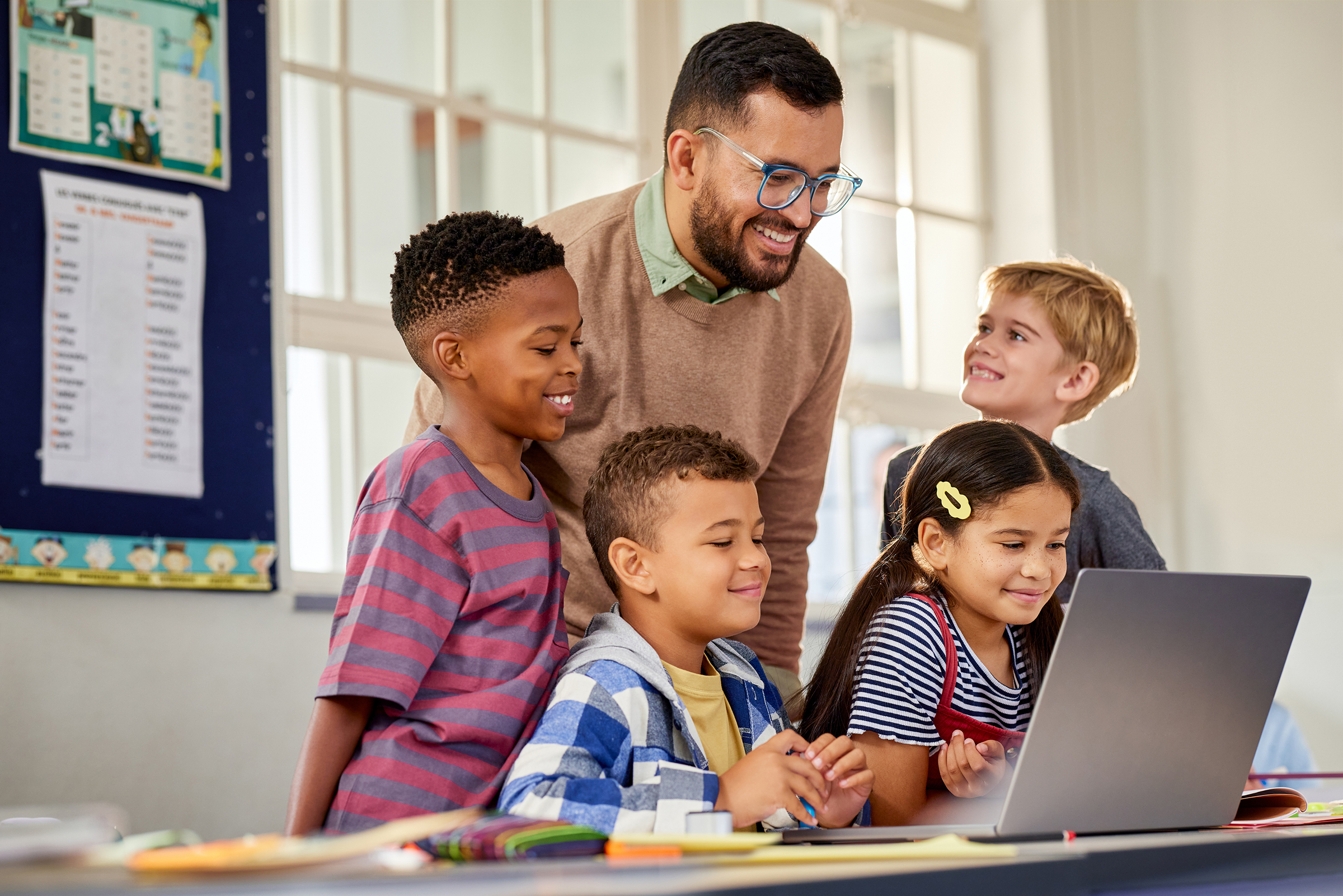 Educator with children and computer